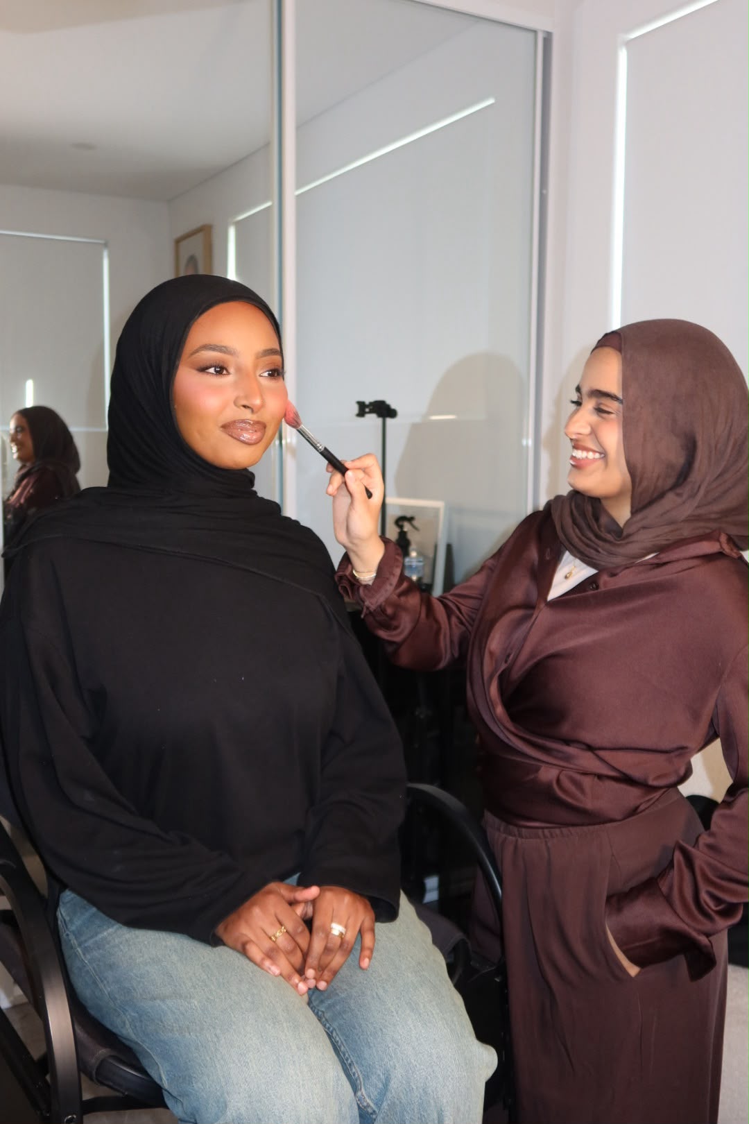 A student practising makeup application on a model during a one to one makeup education session