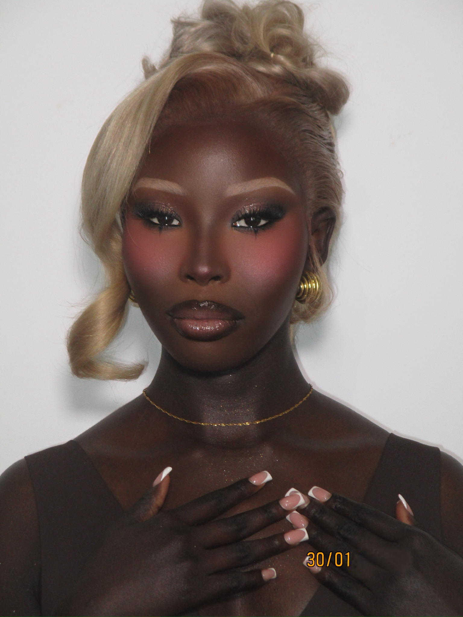 Editorial glam with a smoky eye and blonde updo