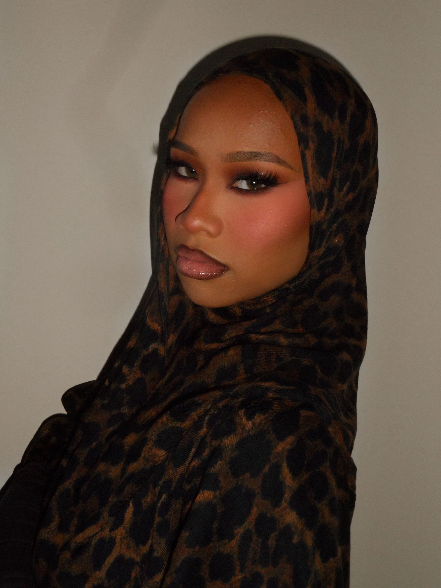 Warm sculpted glam with a soft smoky eye and glossy nude lip