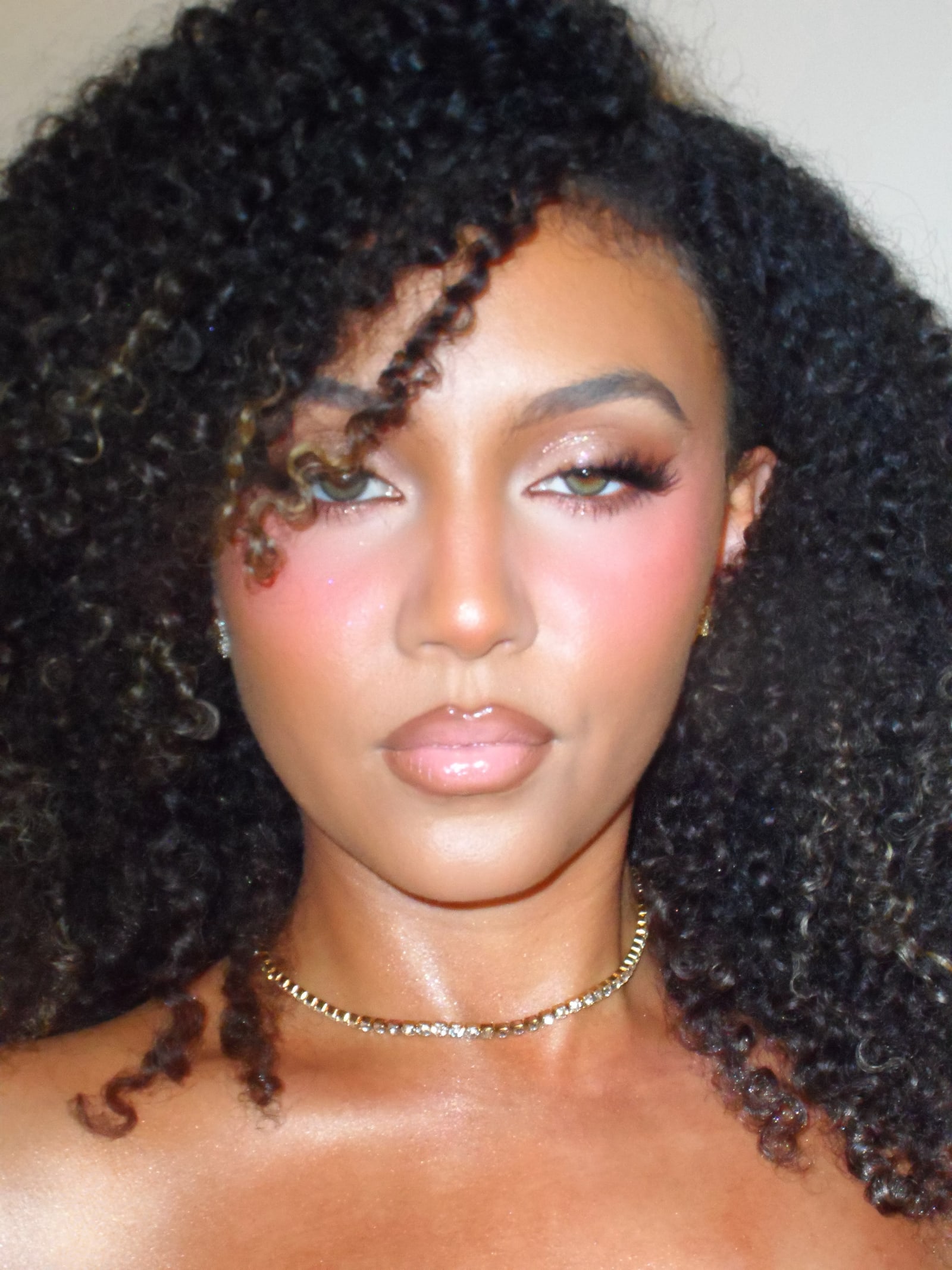 Model with lush RS Artistry lashes and a radiant, glowing glam look